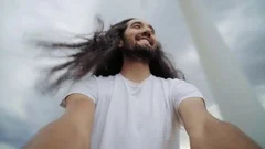 Interesting man with long hair spins around