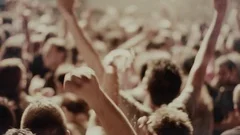 Iconic rock concert front row crowd cheering hands in air slomo crane pan 100p