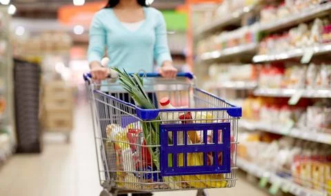 consumerism and people concept - woman with shopping cart or trolley buying food at grocery store or supermarket xkwx shopping, woman, cart, trolley, food, grocery, supermarket, sale, store, shop, buying, market, buyer, shopper, girl, purchaser, young, retail, consumerism, meal, people, person, lifestyle, purchase, customer, consumption, purchasing, consumer, indoors, concept, organic, eco, bio, vegetable, fruit, holding, closeup