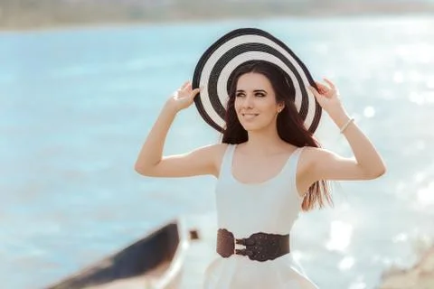 Beautiful girl in a white dress on the seashore near a boat xkwx Woman, girl, young, beautiful, straw, hat, dress, white, black, retro, vintage, elegant, style, stylish, stripes, sea, seashore, shore, boat, water, summertime, season, portrait, belt, big, oversized, outfit, lovely, fashion, sun, beach, sunlight, vitamin D, heliotherapy, tourist, tourism, vacation, holiday, littoral, pretty, pearls, bracelet, smile, happy, perfect, weather