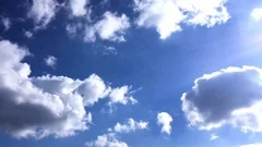 White clouds disappear in the hot sun on blue sky. Time-lapse motion clouds blue