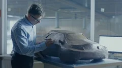 Grey Haired Automotive Designer Sculpts Futuristic  Car Model from Clay