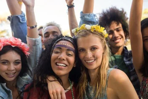 Portrait of smiling friends enjoying together at music festival xkwx Part Of, Man, 20s, Young Adult, Woman, Female, Mixed-race, Male, Caucasian, 30s, Mid Adult, Asian, Smiling, Toothy Smile, Happy, Friend, Enjoying, Music Festival, Lifestyle, Leisure, Casual, Weekend Activities, Together, Bonding, Enjoyment, Fun, Joy, Activity, Recreation, Friendship, Music, Party, Event, Arts Culture And Entertainment, Youth Culture, Celebration, Music Concert, Rock Music, Fan, Arm Around, Arms Raised, Wearing Flowers, Blond Hair, Black Hair, Sunlight, Millennial, Outdoors, Looking At Camera, REUNITEDP5BRIEF