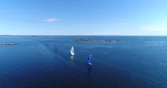 Sailboats on baltic sea, Cinema 4k aerial view of a motorboat and colorful sa