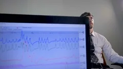 A lie detector data on a screen when a man answers questions.