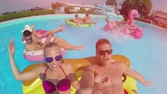 SLOW MOTION LENS FLARE SELFIE friends have water fight on floaties at pool party