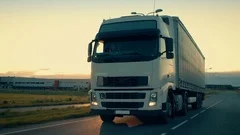 Front-View Camera Follows Semi-Truck with Cargo Trailer Driving on a Highway. 