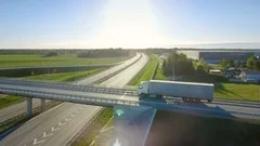 Aerial View of White Semi Truck with Cargo Trailer Passing Highway Overpass
