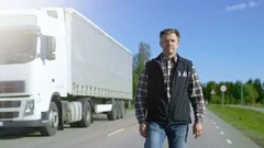 Professional Driver Gets out of the Parked White Semi Truck with Cargo Trailer