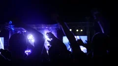 excited audience rocking hands on music festival, arms raised of people in