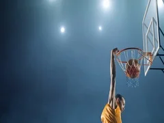 Basketball player makes a slam dunk
