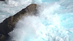 SLOW MOTION: Big powerful wave break crashing violently into rocky reef shoal