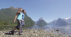 Tourists hiking in New Zealand in Milford Sound by Mitre Peak in Fiordland
