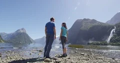 New Zealand - tourists hiking standing looking at Milford Sound