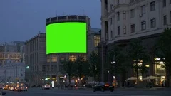 A large billboard, on an ancient building, on a busy street. Green screen.