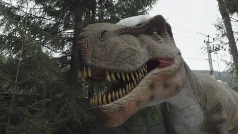 08 Dec 2024, Bukovel, Ukraine. Moving artificial dinosaur sculpture Stock Footage 294880255