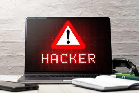  08 July 2023: Warning of a computer hacker on a laptop in an office PHOTO... Stock-Fotos