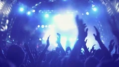 4K Night rock concert front row crowd cheering hands in air