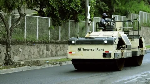 On 08/07/2023, skilled workers and machinery transform roads in San Salvado.. Stock-Footage 247877034