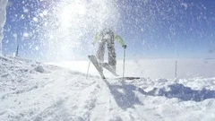 SLOW MOTION Skier starts to ski on a sunny winter day at the top of the mountain