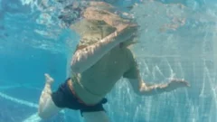 Man dive take out from pool bottom drown smartphone