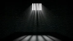 empty dark jail with light rays on window