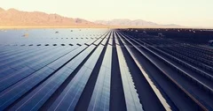 Aerial view flying over large solar farm in desert, clean renewable energy