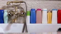 Row of cosmetic products on the bathtub