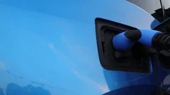 Color footage of charging a blue electric car