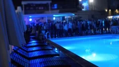 Pool party night in the open air summer Club where People Move Blurred