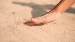 Female Hand Drawing Calm Lines on White Sand at Tropical Island Beach in