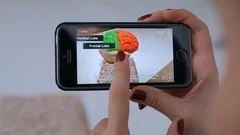 Woman using smartphone with augmented reality app and exploring virtual model