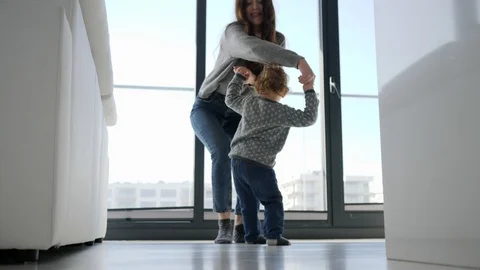 084 Fun and diversion young mother and little child son dancing near big wind Stock Footage 103224453