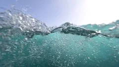 SLOW MOTION UNDERWATER: Endless bubbles creating underwater in clear blue ocean