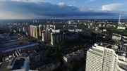 Aerial view of a modern city at sunset. Clip. Top view of the city in summer at