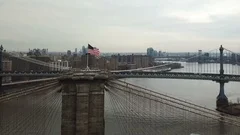circling Brooklyn Bridge American flag aerial Manhattan skyline New York City HD