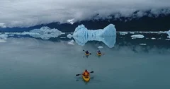 Drone footage of people kayaking towards glacier, Alaska, USA