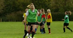 4K British high school girls practicing soccer skills on school sports field