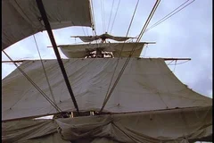 Ship's mast with unfurled sails
