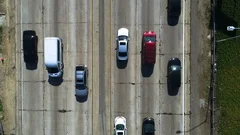 overhead view of traffic driving on freeway. Aerial shot