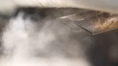 Old car exhaust pipes releasing a lot of gas at starting up, stock video