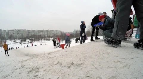 09.01.2016 Belarus, Minsk. Children ride on a hill in the city. Video stock 59141351