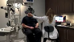 Male patient at the eye doctor getting an eye exam