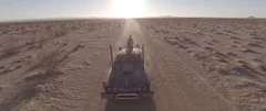 Drone video of Mad Max-inspired Car Driving Thru Desert