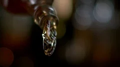 Pouring whisky from the bottle at vintage bar in super slow motion. Shot with