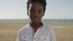 close up portrait of cute african american boy looking serious pensive at camera