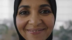 close up portrait of middle aged muslim business woman smiling looking cheerful