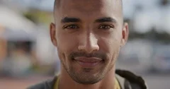close up portrait of handsome hispanic man smiling cheerful looking at camera