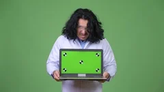 Crazy scientist showing laptop