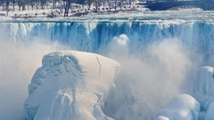 American side of Niagara Falls in winter. Water falls on blocks of ice and snow
